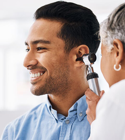 Young man happy to be having ear exam