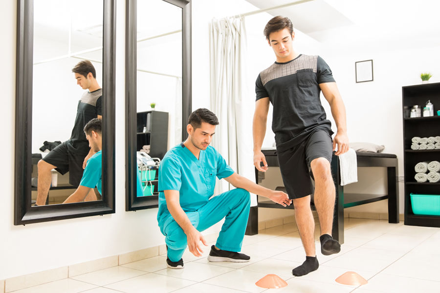 Physical therapist helping patient with balance