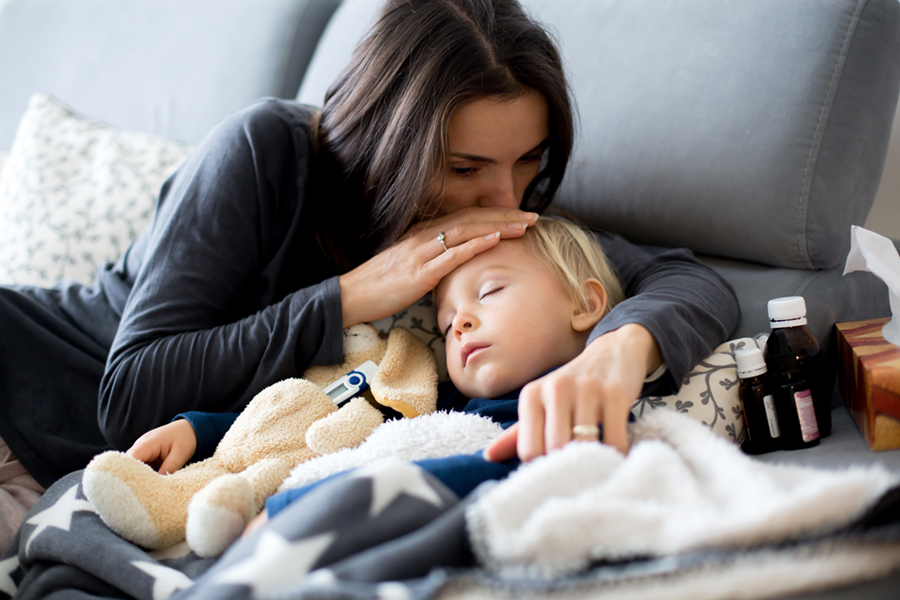 Mother comforting sick child