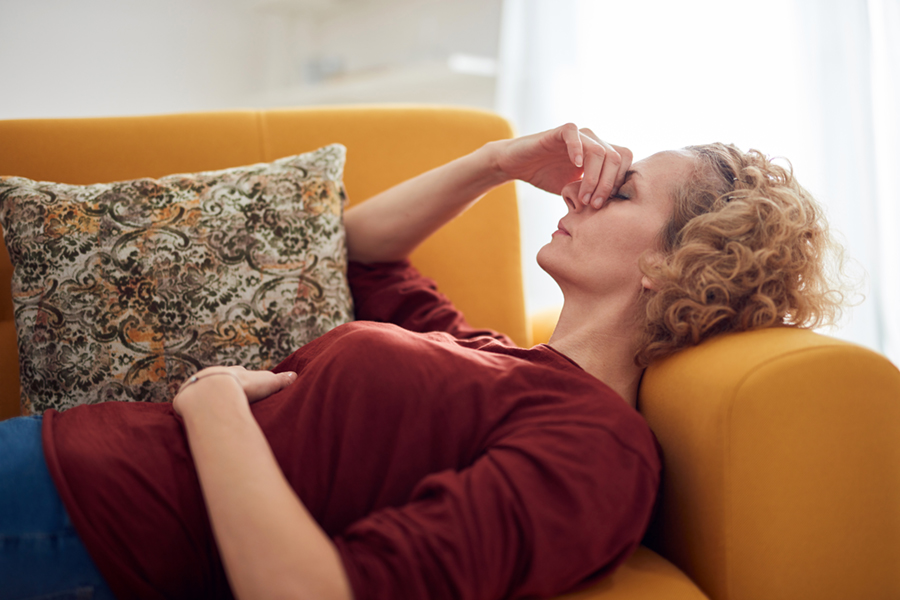 Woman on couch with sinus pain